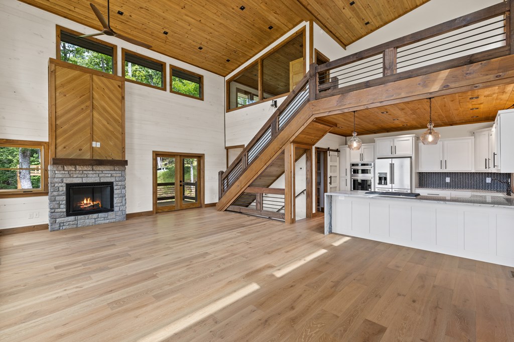 394 Mountain Trace Cherry Log, GA 30522 - Photo 16 of 70 a view of a livingroom with wooden floor and a fireplace