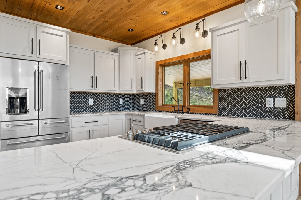 394 Mountain Trace Cherry Log, GA 30522 - Photo 21 of 70 a kitchen with stainless steel appliances granite countertop a stove a sink and a refrigerator