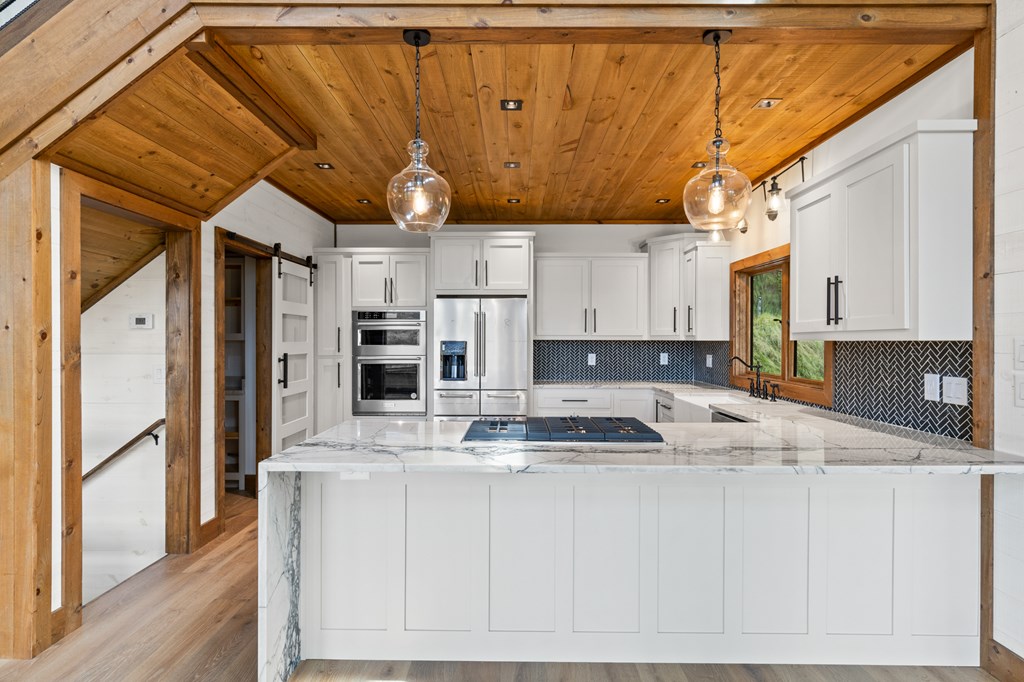 394 Mountain Trace Cherry Log, GA 30522 - Photo 23 of 70 a kitchen with stainless steel appliances granite countertop a sink a stove and a refrigerator