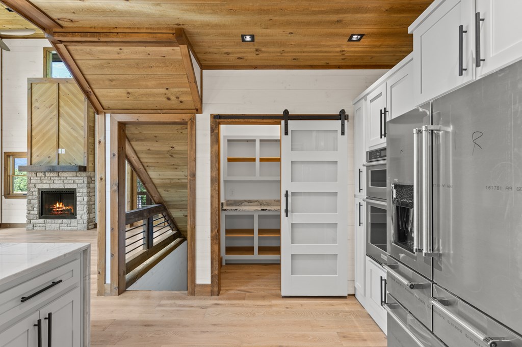 394 Mountain Trace Cherry Log, GA 30522 - Photo 25 of 70 a view of a hallway with wooden floor and a fireplace