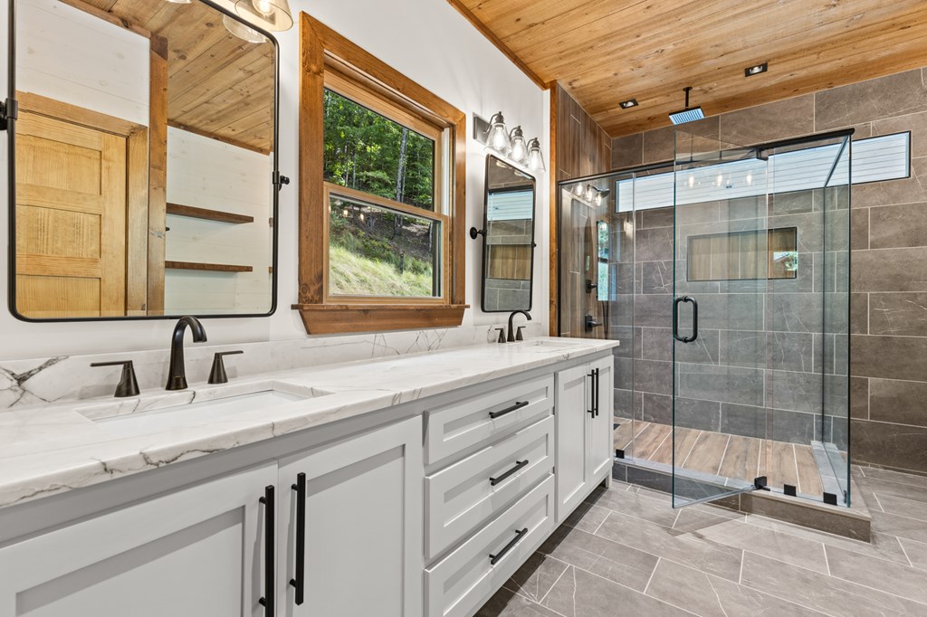394 Mountain Trace Cherry Log, GA 30522 - Photo 31 of 70 a bathroom with a shower sink and mirror