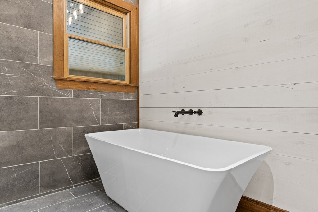 394 Mountain Trace Cherry Log, GA 30522 - Photo 33 of 70 a white bath tub sitting in a bathroom