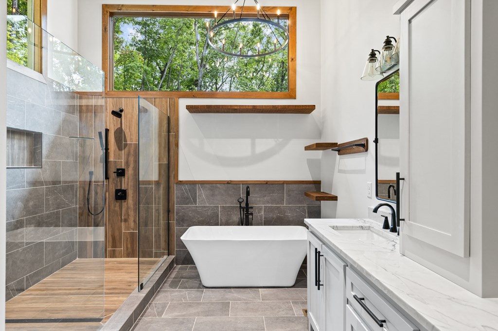 394 Mountain Trace Cherry Log, GA 30522 - Photo 40 of 70 a bathroom with a granite countertop tub sink and mirror