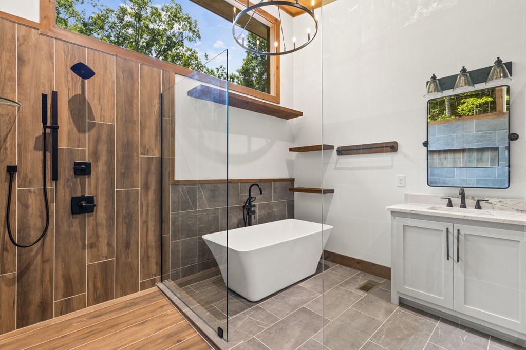 394 Mountain Trace Cherry Log, GA 30522 - Photo 43 of 70 a bathroom with a sink and mirror with bathtub