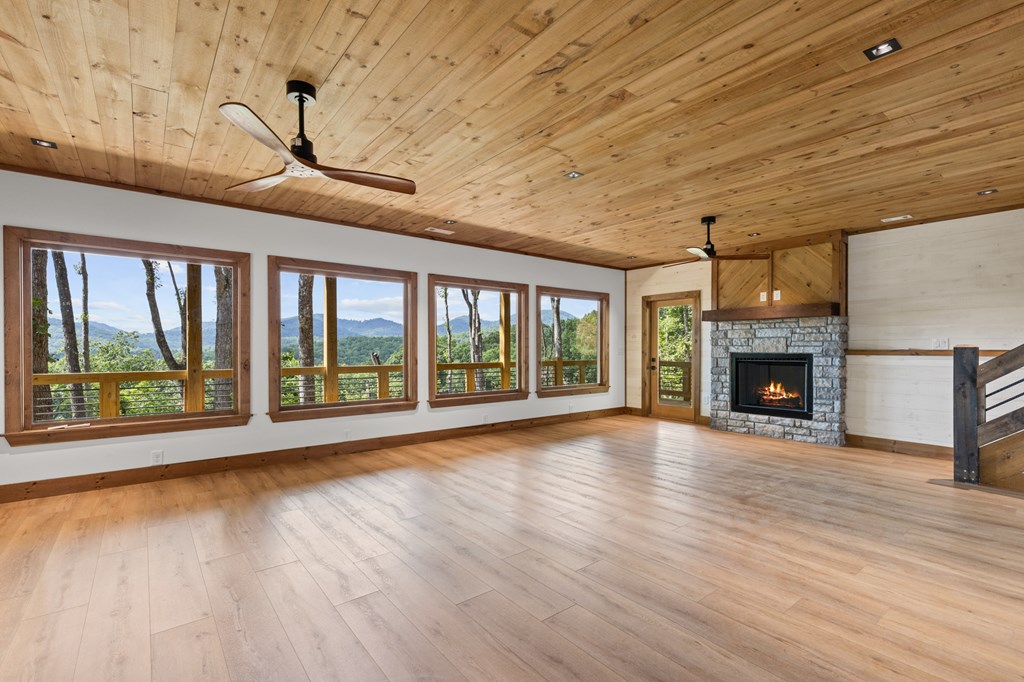 394 Mountain Trace Cherry Log, GA 30522 - Photo 51 of 70 a view of an empty room with wooden floor fireplace and a window