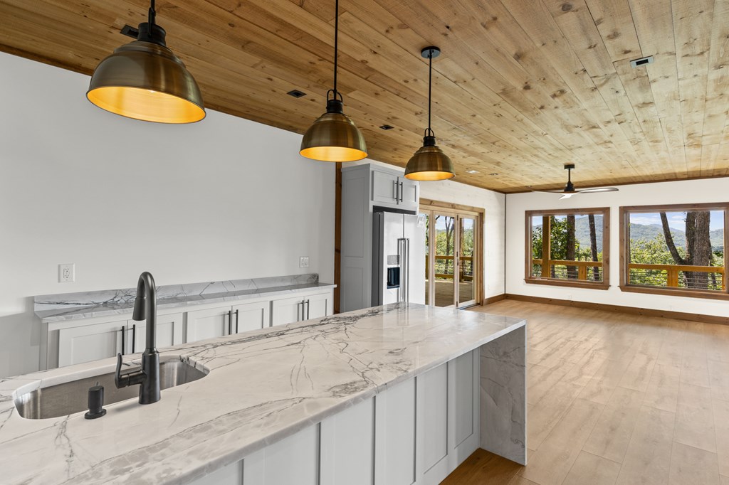 394 Mountain Trace Cherry Log, GA 30522 - Photo 55 of 70 a kitchen with stainless steel appliances granite countertop a sink a stove and a wooden floors