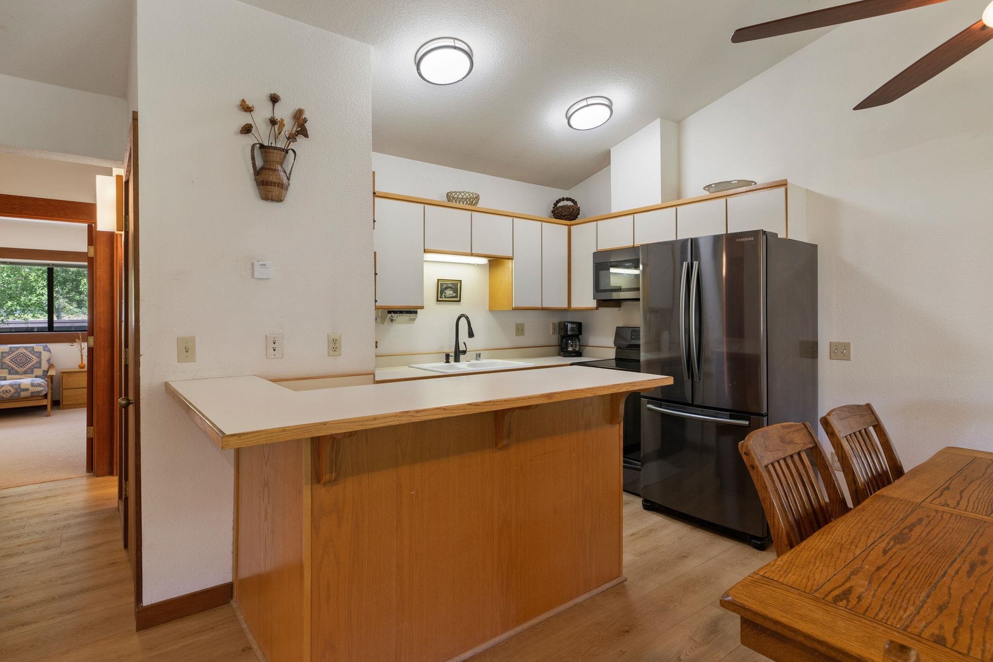 1591 Olympic Vly Road, Unit 29 Olympic Valley, CA 96146 - Photo 4 of 28 a kitchen with stainless steel appliances a refrigerator a sink and a refrigerator