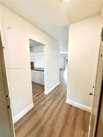 a view of a kitchen from a hallway