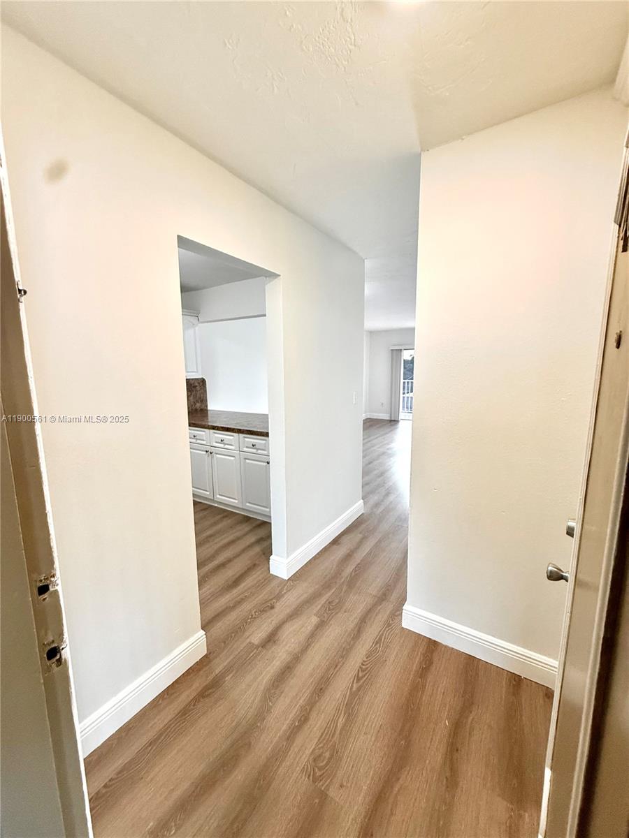 a view of a kitchen from a hallway