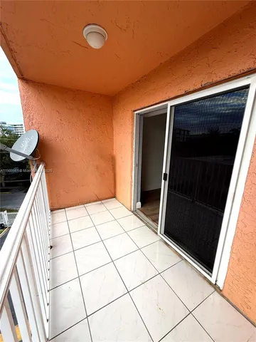 a view of an empty room and wooden floor