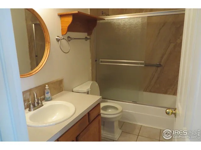 a bathroom with a sink mirror vanity and toilet
