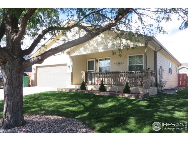 a front view of house with a garden and patio