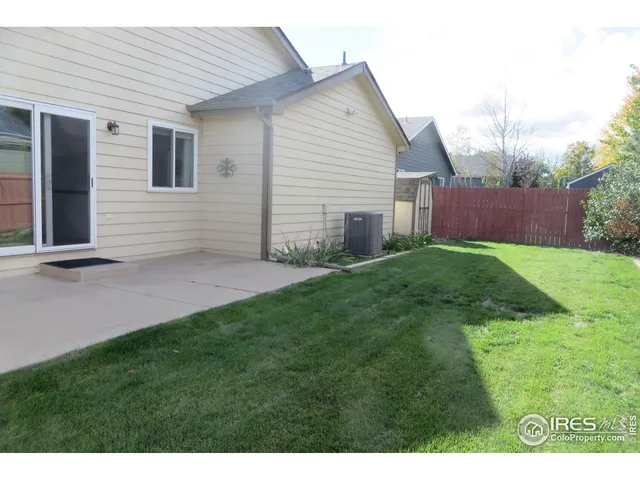 a view of backyard of house and trees