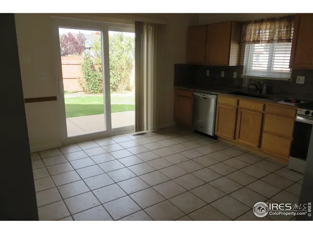 a kitchen with a sink a window and cabinets
