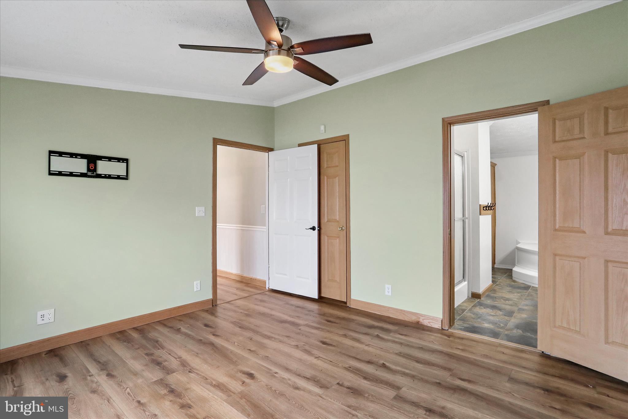 3688 Ash Ruckman Road Augusta, WV 26704 - Photo 20 of 66 an empty room with wooden floor and a ceiling fan