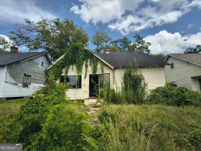 a view of a house with a yard and garden