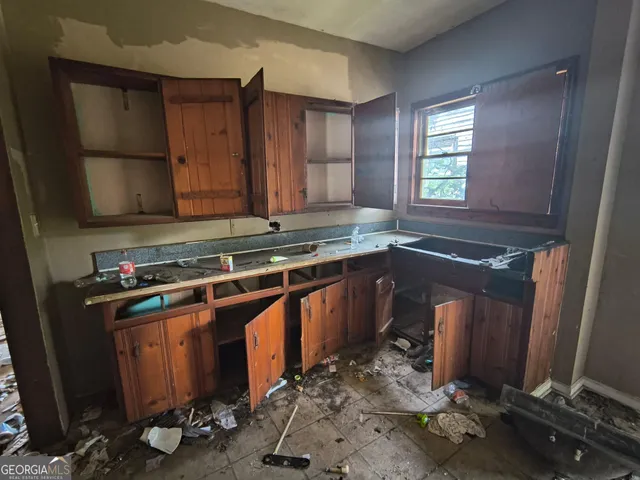 a kitchen with a sink stove and cabinets