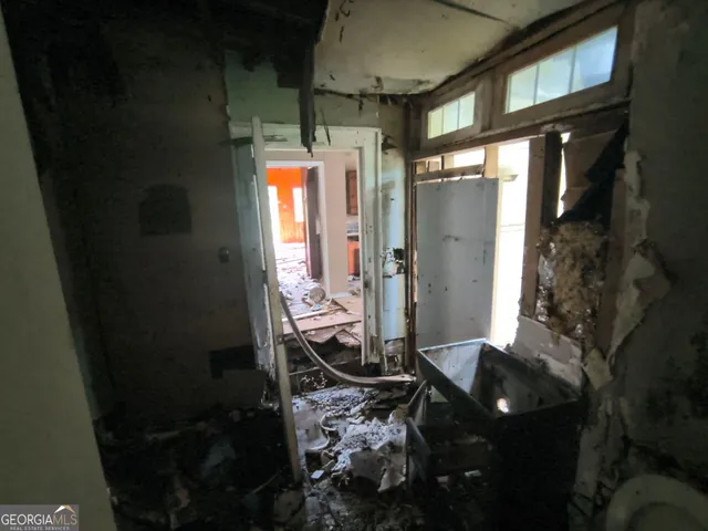 a bathroom with a glass shower door and a wooden table
