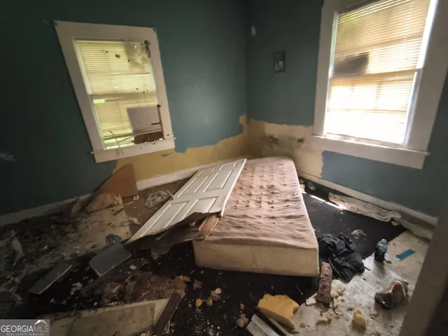 a bedroom with a bed and a window