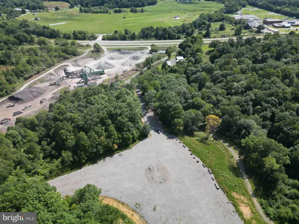 an aerial view of a house with a yard and lake view