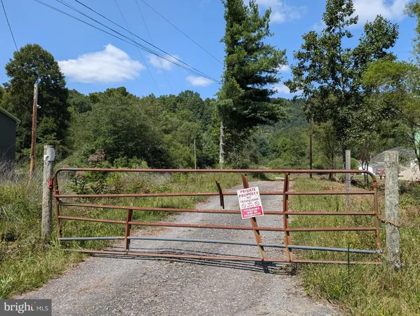 a view of a green field with sitting area