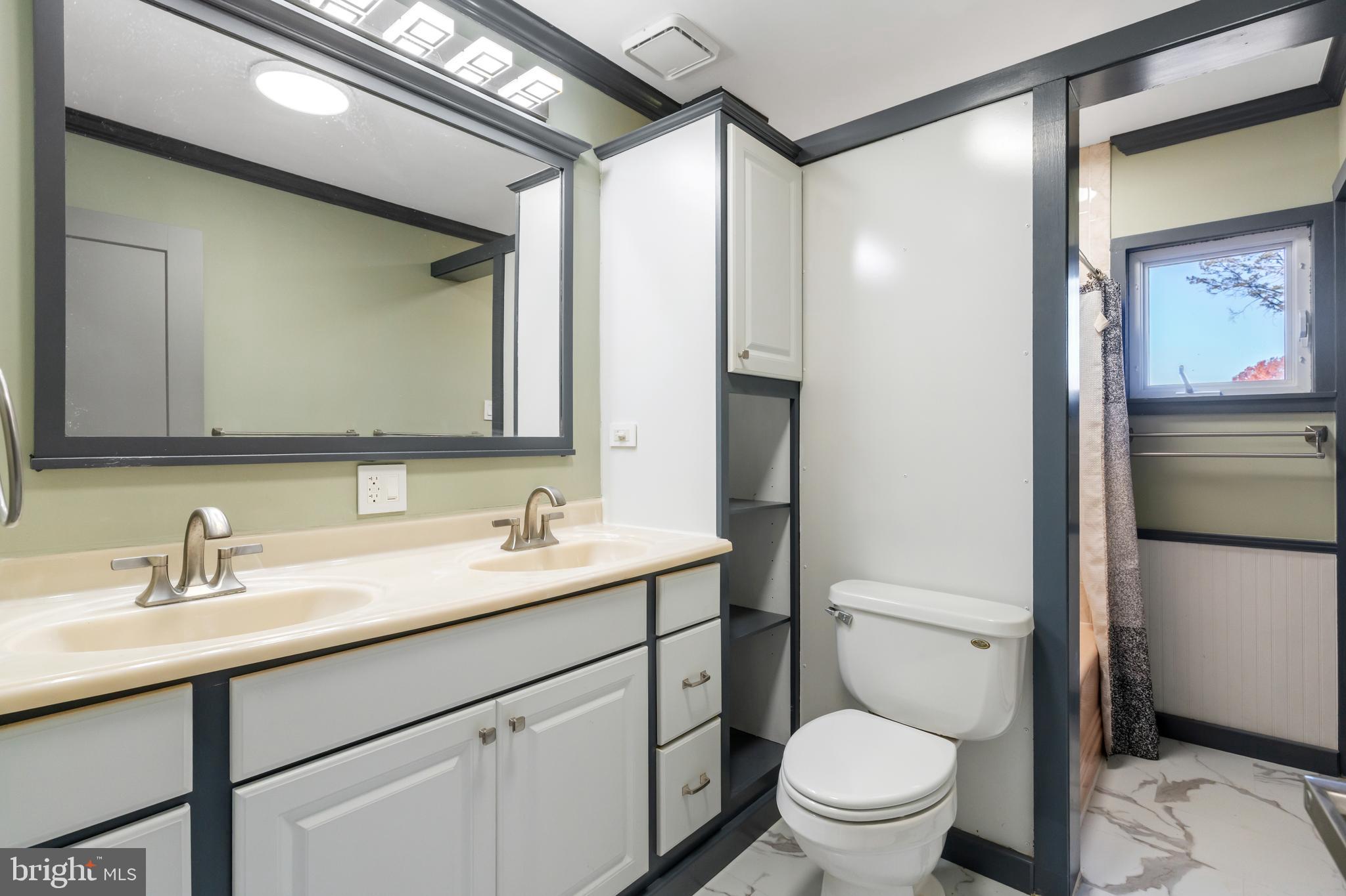 3211 Pricetown Road Fleetwood, PA 19522 - Photo 29 of 71 a bathroom with a toilet a sink a mirror a vanity and shower