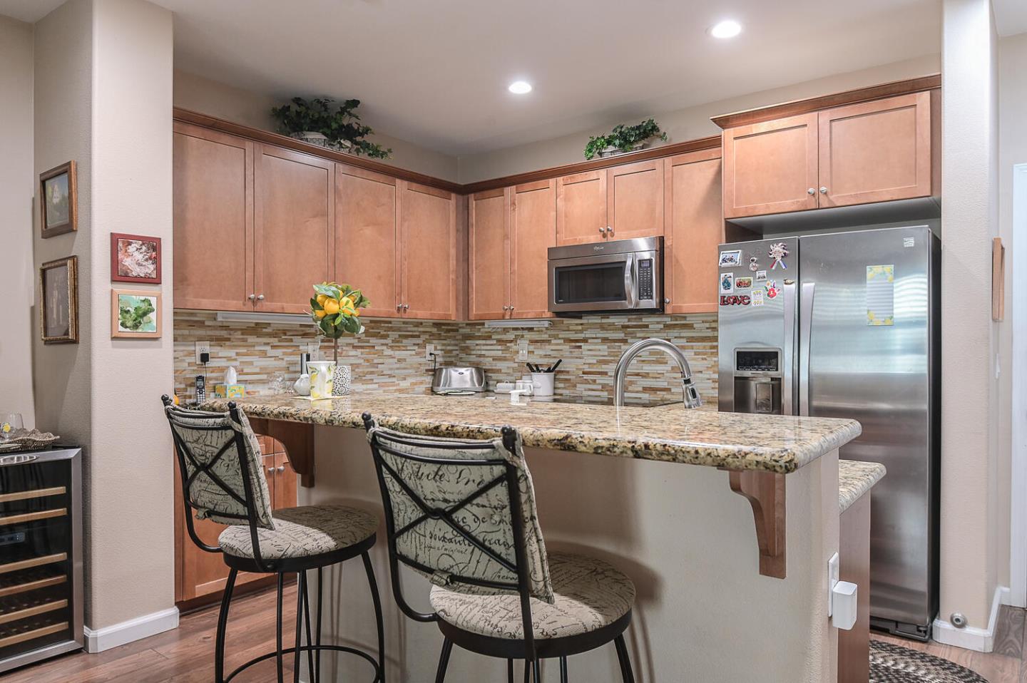 124 Larkspur Loop Morgan Hill, CA 95037 - Photo 11 of 26 a kitchen with stainless steel appliances granite countertop a stove a sink a microwave a refrigerator and cabinets