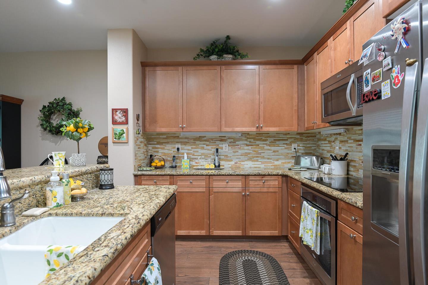 124 Larkspur Loop Morgan Hill, CA 95037 - Photo 12 of 26 a kitchen with granite countertop a sink a stove and cabinets