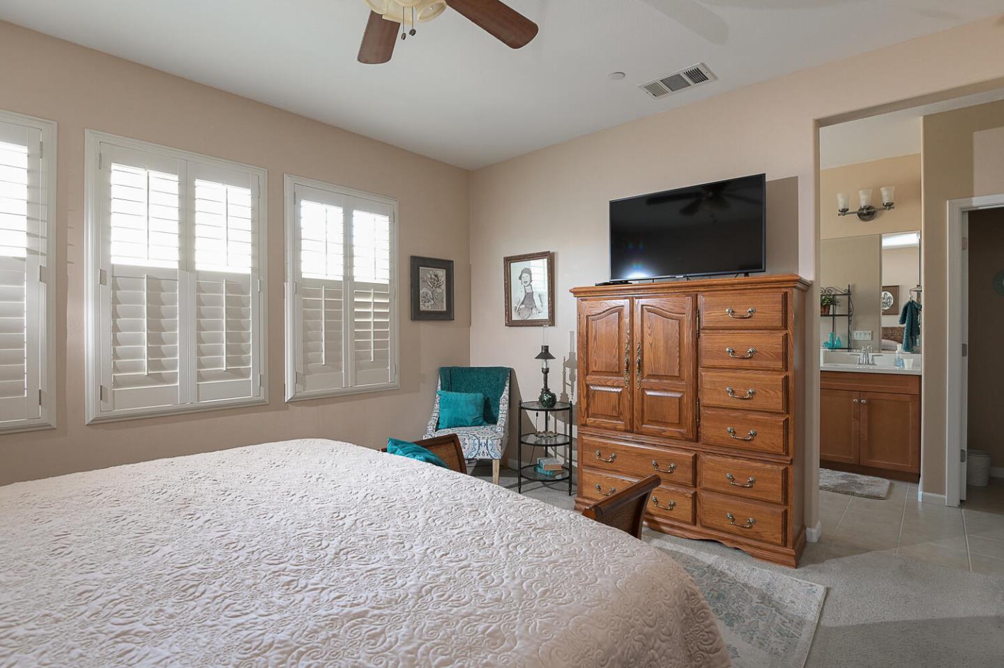 124 Larkspur Loop Morgan Hill, CA 95037 - Photo 16 of 26 a bedroom with a bed and a flat screen tv