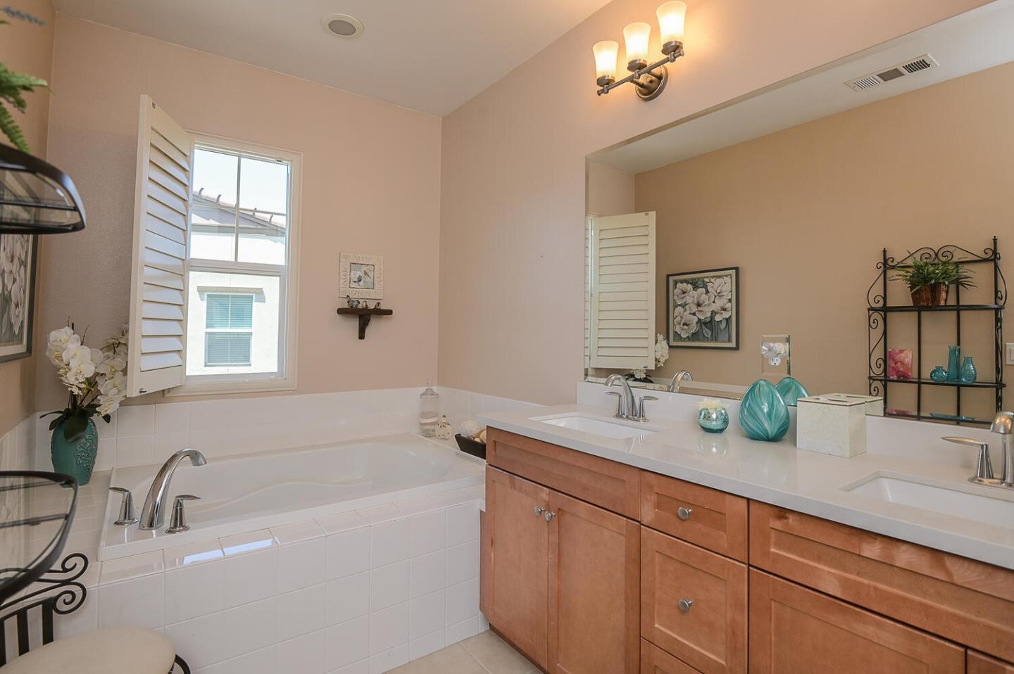 124 Larkspur Loop Morgan Hill, CA 95037 - Photo 17 of 26 a bathroom with a tub a sink and mirror