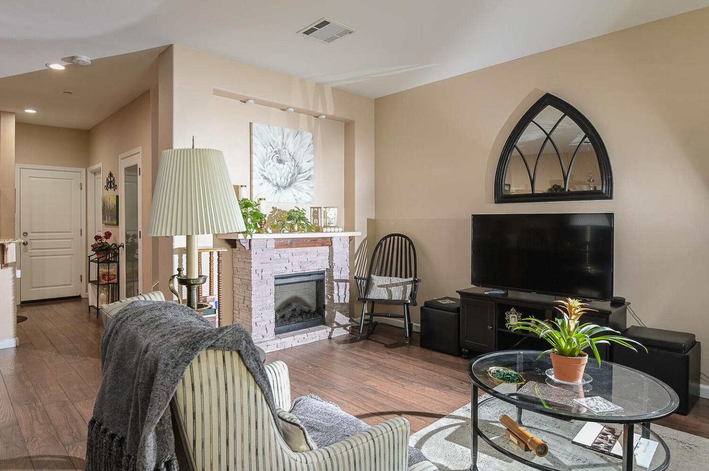 124 Larkspur Loop Morgan Hill, CA 95037 - Photo 6 of 26 a living room with furniture a flat screen tv and a fireplace