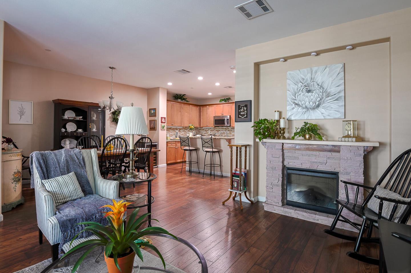 124 Larkspur Loop Morgan Hill, CA 95037 - Photo 8 of 26 a living room with furniture a fireplace and a floor to ceiling window