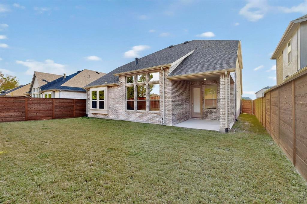 2017 Fall Crk Cove Mesquite, TX 75181 - Photo 34 of 40 Rear view of property with a patio area, roof with shingles, brick siding, and a fenced backyard