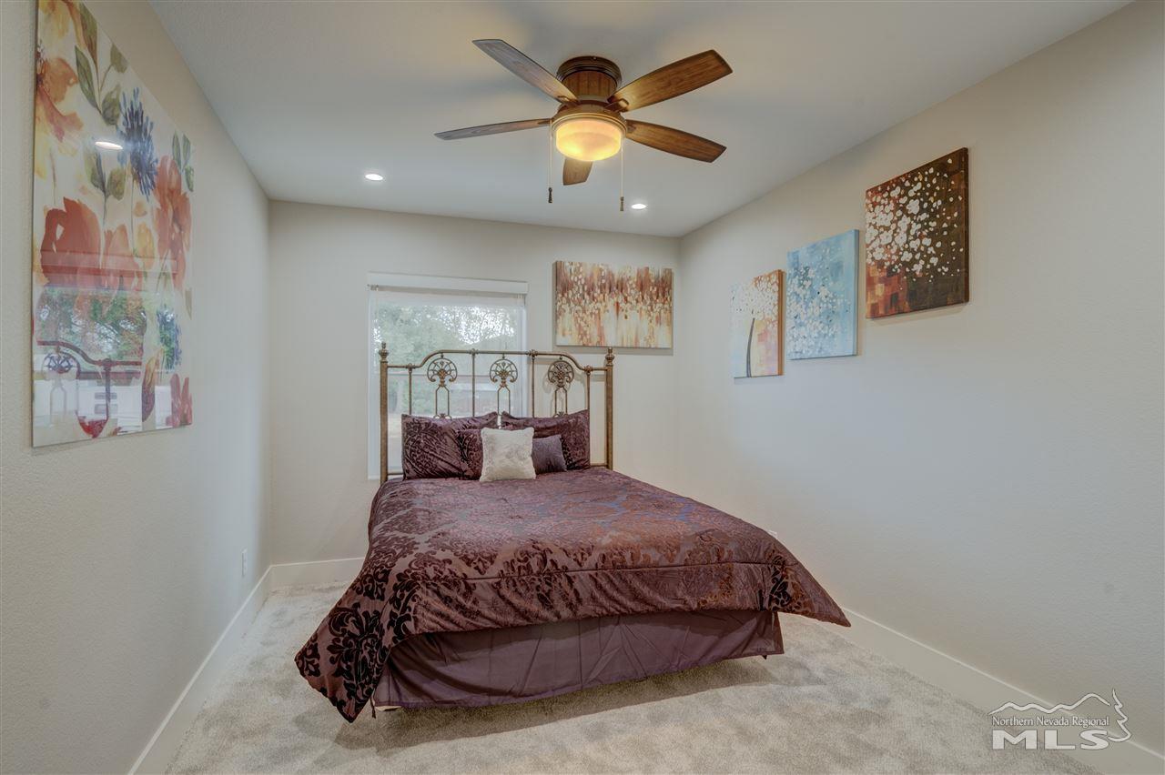 2160 Dickerson Road Reno, NV 89503 - Photo 15 of 35 a bedroom with a bed and a chandelier
