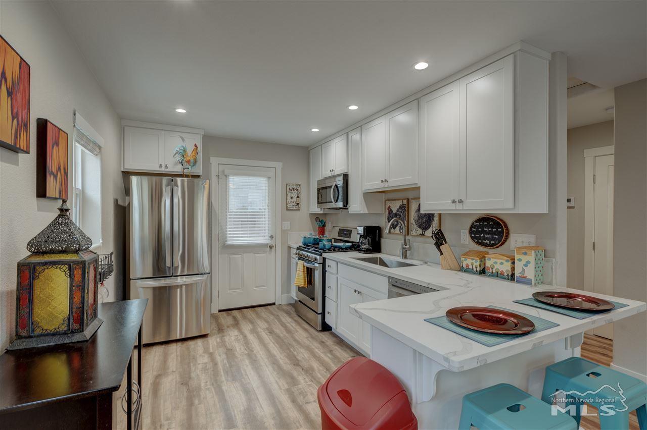 2160 Dickerson Road Reno, NV 89503 - Photo 19 of 35 a kitchen with stainless steel appliances granite countertop a stove refrigerator and a sink