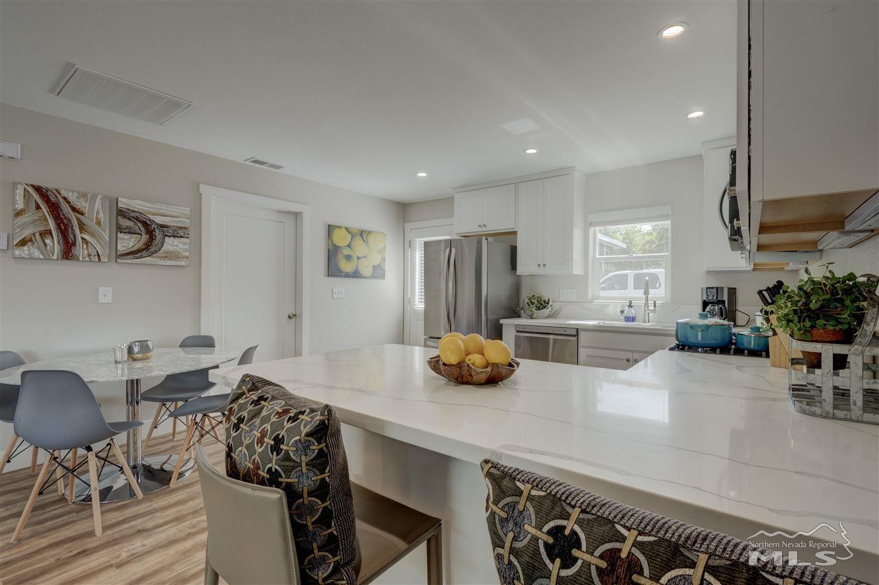 2160 Dickerson Road Reno, NV 89503 - Photo 9 of 35 a kitchen with stainless steel appliances a table and chairs in it