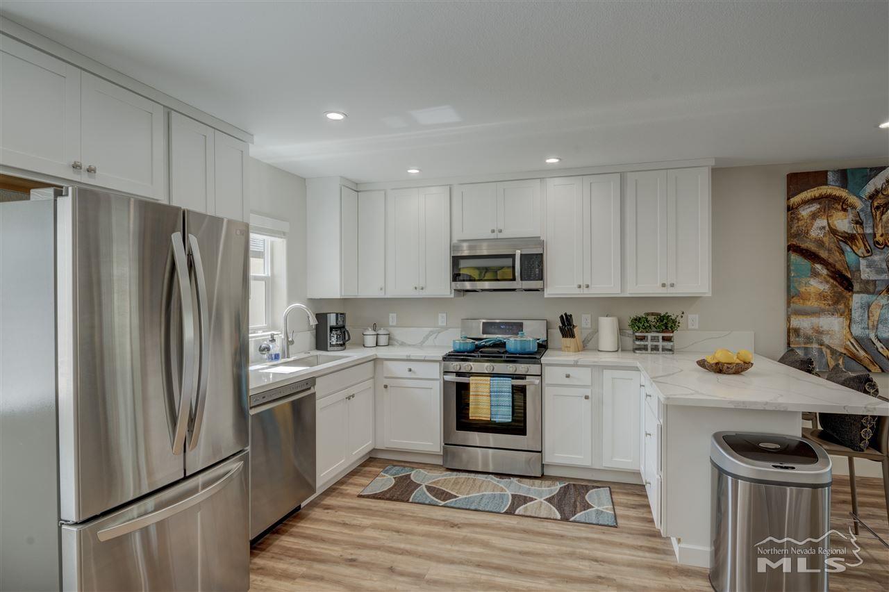 2160 Dickerson Road Reno, NV 89503 - Photo 10 of 35 a kitchen with stainless steel appliances a refrigerator stove microwave and sink