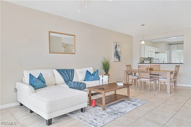 a living room with furniture and a dining table
