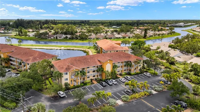 an aerial view of residential houses with outdoor space and lake view