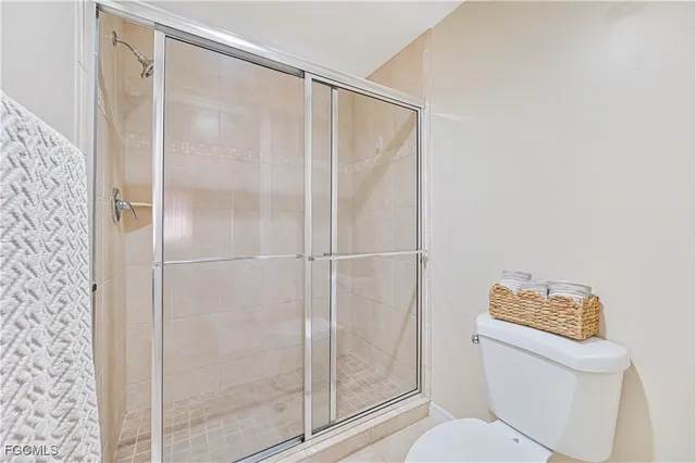 a bathroom with a shower a toilet and a shower