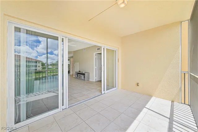 a view of a room with a balcony and glass door