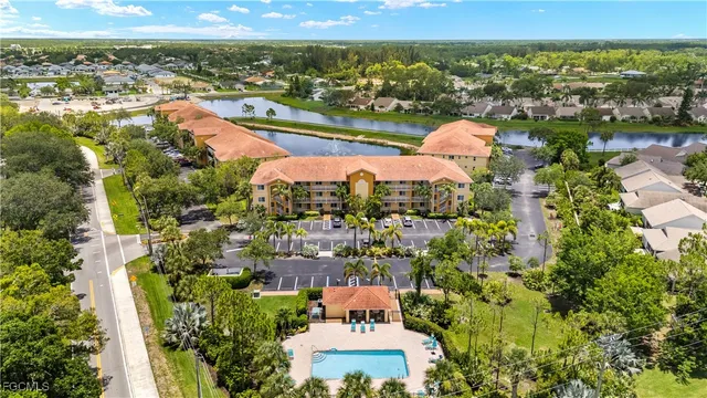 an aerial view of residential houses with outdoor space and river