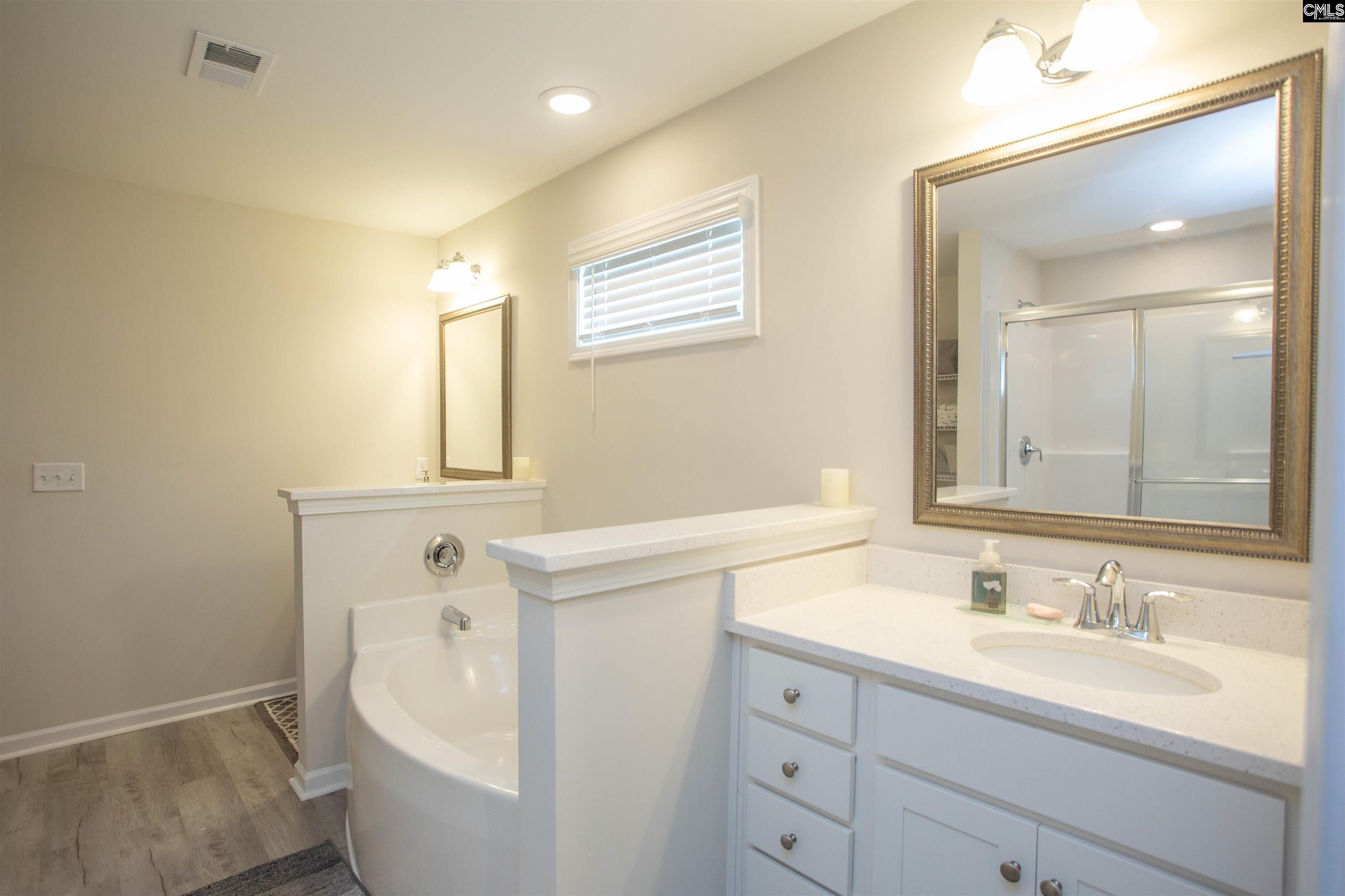 272 Shadowbrook Way Camden, SC 29020 - Photo 21 of 43 a bathroom with a toilet a sink a mirror and vanity