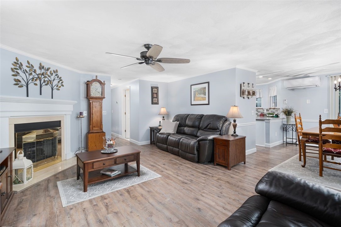 34 Eagle Run, Unit 34B Warwick, RI 02818 - Photo 4 of 23 Open layout - living room with gas fireplace flows into the dining area.
