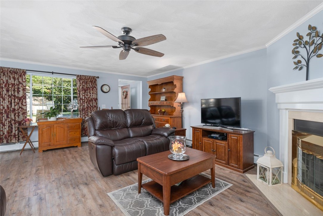 34 Eagle Run, Unit 34B Warwick, RI 02818 - Photo 5 of 23 Large front windows, overhead fan and luxury vinyl plank flooring throughout the living room, dining area, kitchen and hall.