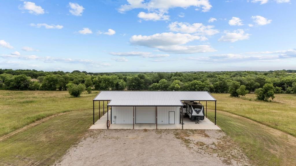 1161 Alsdorf Road Ennis, TX 75119 - Photo 16 of 28 Modern metal building featuring a white facade and dark trim
