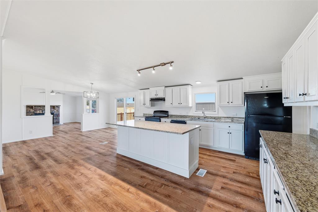 237 Quarterhorse Road Waxahachie, TX 75165 - Photo 14 of 38 a kitchen with granite countertop a sink cabinets stainless steel appliances and a counter top space