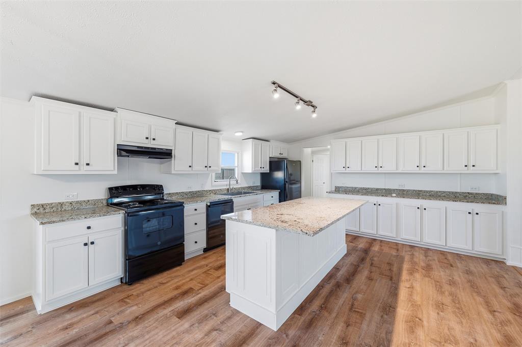 237 Quarterhorse Road Waxahachie, TX 75165 - Photo 15 of 38 a kitchen with granite countertop white cabinets and white appliances