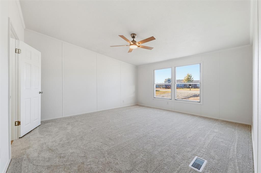 237 Quarterhorse Road Waxahachie, TX 75165 - Photo 21 of 38 an empty room with windows and ceiling fan
