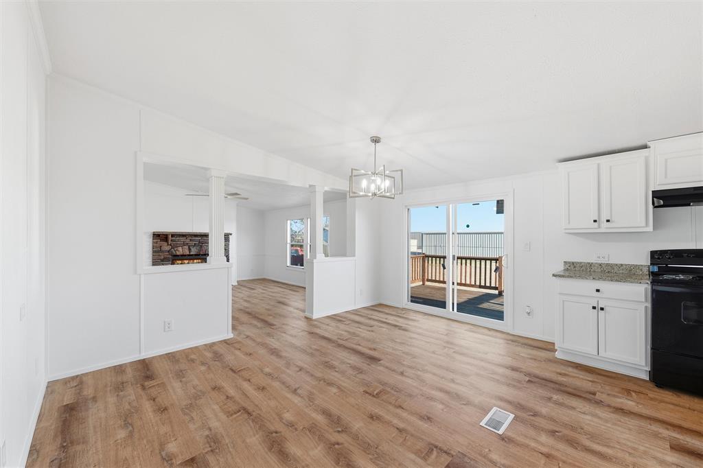 237 Quarterhorse Road Waxahachie, TX 75165 - Photo 8 of 38 a view of a kitchen with wooden floor and windows